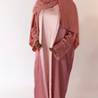 Load image into Gallery viewer, Women&#39;s reversible 2-in-1 abaya 3-piece set in pink and light pink. Includes an outer abaya, underdress, and matching hijab in a darker pink shade. Versatile modest wear, perfect for any occasion. High-quality satin fabric, elegant design, and modest fashion essentials. One set, multiple ways to style.
