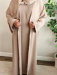 Load image into Gallery viewer, Image of a model wearing our classic taupe open abaya. The abaya can be styled open or closed, offering versatility for any occasion. It&#39;s perfect for all seasons and can be easily dressed up or down for a chic look. 
