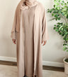 Load image into Gallery viewer, Image of a model wearing our classic taupe open abaya. The abaya can be styled open or closed, offering versatility for any occasion. It&#39;s perfect for all seasons and can be easily dressed up or down for a chic look. 
