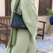 Load image into Gallery viewer, Women wearing long dress with chic black shoulder bag on her shoulder with zipper 
