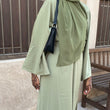 Load image into Gallery viewer, Women wearing long dress with a small  black leather shoulder bag with zipper 
