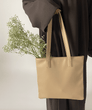 Load image into Gallery viewer, Women holding vegan leather tote bag 
